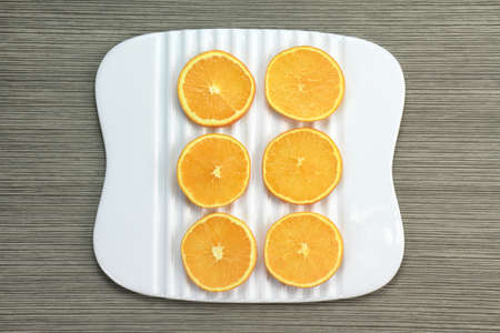 Sliced orange on white dish.の写真素材