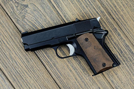 Small black gun (compact handgun) Isolated On White Background, .45 pistol, Women gun.の写真素材