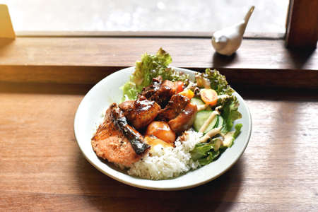 Braised belly pork and charcoal grilled salmon with rice.の写真素材
