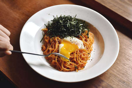 Pasta spicy garlic and cods (mentaiko) with soft boiled egg, Fusion style japanese food.のeditorial素材