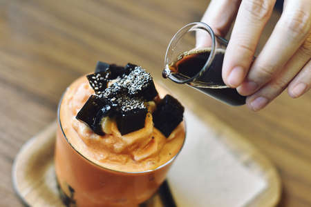Cold drinks or dessert in fusion style, Milk tea frappe with grass jelly.の写真素材
