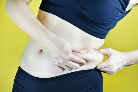 Overweight fat woman, Middle-aged woman with excessive belly fat, Side view of woman muffin top...