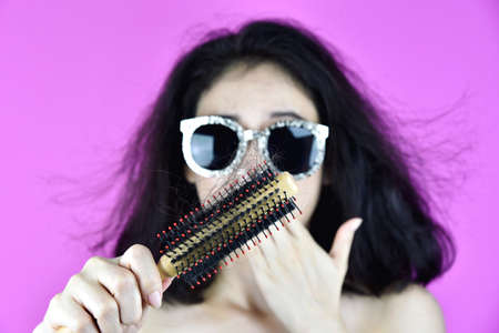 Hair fall problem, Woman with hair brush worry about hair loss.