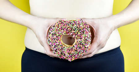 Overweight fat woman from sweet donut and bad junk food, Middle-aged woman with excessive belly fat,...
