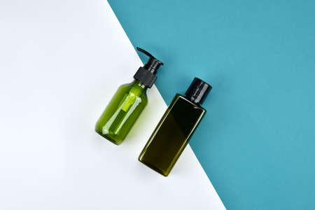 Cosmetic bottle containers, Blank label for branding mock-up, Flat lay on color background.