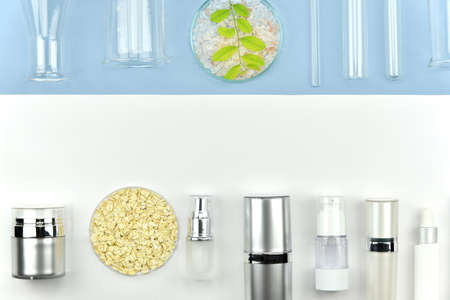 Collection of cosmetic bottle containers and laboratory glassware, Blank label for branding mock-up, Flat lay on color background, Beauty product research and development concept.の写真素材