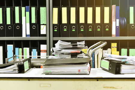 Work hard, Lot of work, Stacks of document paper and files folder on office desk.の写真素材
