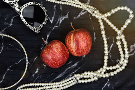 Apple fruit vitamin as natural cosmetics, Woman accessories, sunglasses, pearl necklace, head band...