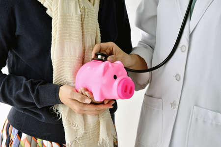 Medical financial check up with a stethoscope, Money savings for healthcare treatment.の写真素材