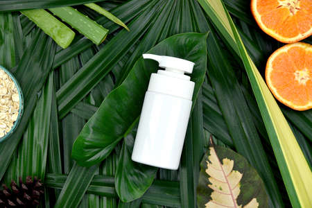 Cosmetics skincare with vitamin-c extract, Cosmetic dropper bottle containers with fresh orange slices, Blank label for branding mock-up, Natural Vitamin C beauty product concept.の写真素材