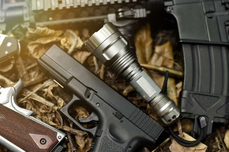 Tactical flash light and assault rifle gun weapon. LED Pocket flashlight.の写真素材