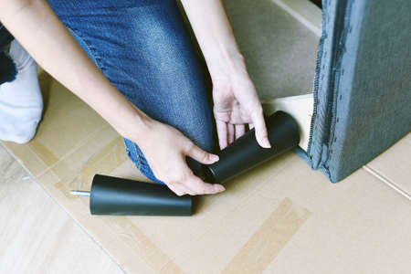 Furniture assembly, Woman looking at the furniture assembly manual, Unpack furniture for new home.の写真素材