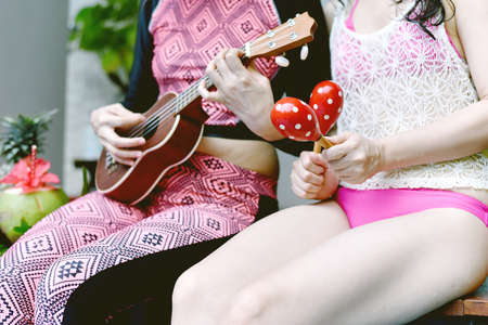 Summer time relaxing pool party, Girlfriends enjoy playing and singing by the swimming pool on...