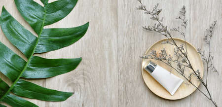 Cosmetic bottle containers with green herbal leaves, Blank label package for branding mock-up,...