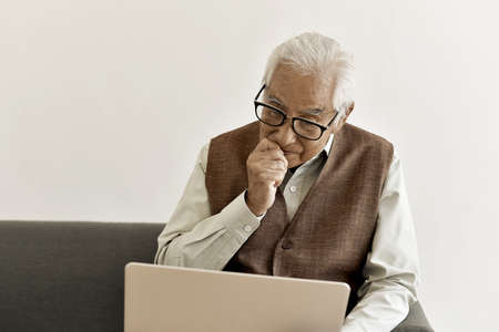 Vision loss problems and difficult to read in senior, Eye diseases in old adult, Asian elderly man...