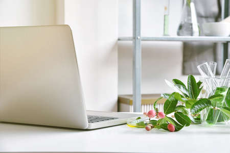 Laptop computer use for natural organic extraction research and drug development concept....