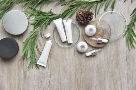 Cosmetic bottle containers packaging with green herbal leaves, Blank label for organic branding...