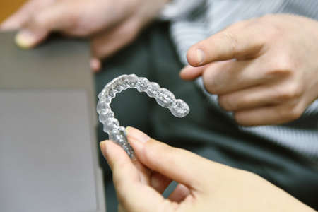 Inivisalign braces or aligner. Dentist advice how invisible orthodontics make beautiful teeth in...