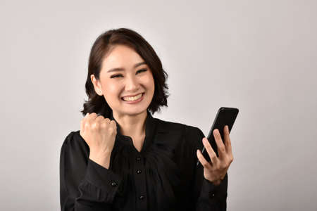 Confident expert woman secretary smiling and working at office, Asian business woman using...
