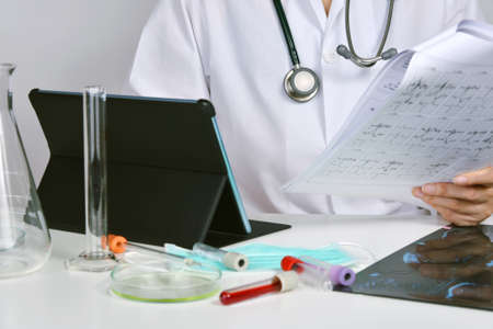 Health check up report chart, Doctor analyzing medical test and biological data, Blood result and medical equipment for health check up.の写真素材