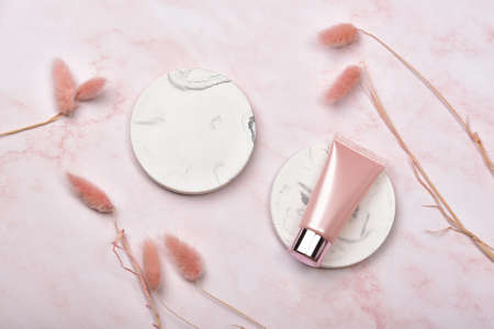 Cosmetic bottle containers on pink marble background, Blank label package for branding mock-up, Natural organic beauty product concept, Research and development of purified skincare.の写真素材