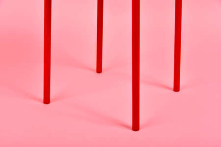 Minimal interior style, Detail of red metal chair leg on pastel pink background, Minimalism furniture.の写真素材