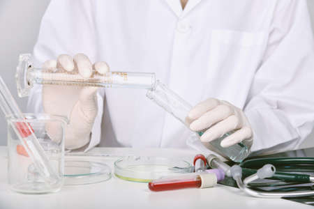 Scientists researching in laboratory, Chemist holding scientific glassware equipment, Healthcare and research concept.の写真素材