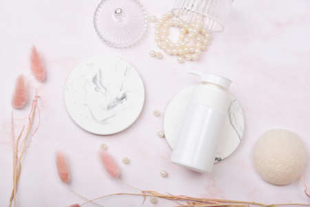 Cosmetic bottle containers on pink marble background, Blank label package for branding mock-up,...