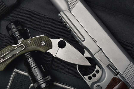 Weapons and military equipment for army, Semi-automatic handgun .45 pistol tactical flash light and pocket army knife.の写真素材