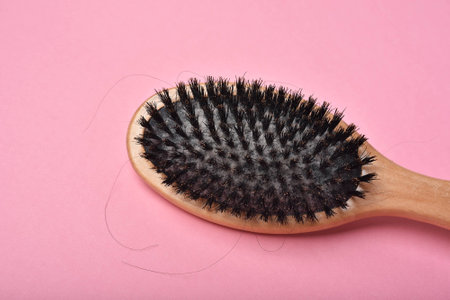 Dirty hair brush, Grey lint dead skin cell residue on unclean comb, Poor hygiene head scalp, Hair fall problem.の写真素材