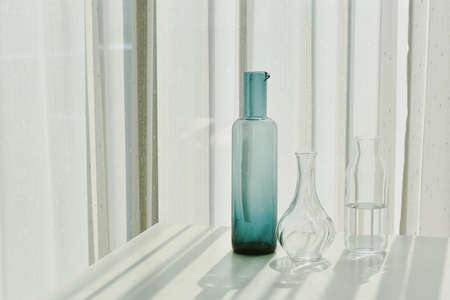 Glassware reflect sunlight shadow effect, Summer still life scene, Transparent glittering glasses of...