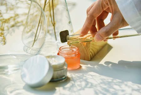 Scientist mixing natural skin care beauty products, Organic botany extraction and scientific...