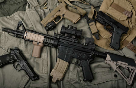 BANGKOK, THAILAND - April 3, 2022 : Colt's M4A1 weapons and military equipment for army, Assault rifle gun and pistol on camouflage background.のeditorial素材