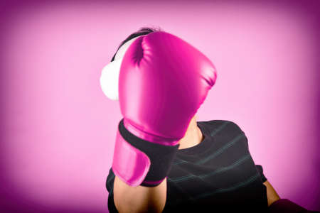 Asian man hitting a punch by vr glasses, Working out with boxing video games application from virtual reality headset, Young man enjoy new fitness experience by vr technology, Studio shot.の写真素材