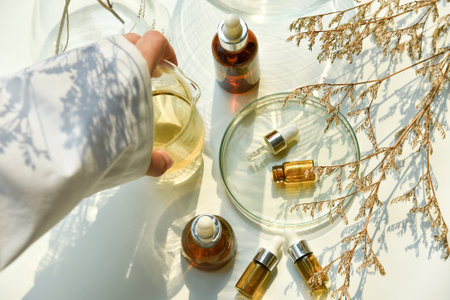 Scientist mixing natural skin care beauty products, Organic oil botany extraction and scientific laboratory glasswareの写真素材