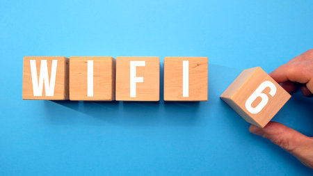 A hand pushes the cubes and forms the inscription Wi Fi 6.