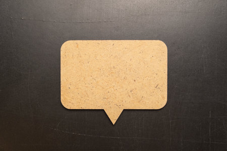 Wooden speech bubble chalkboard on blackboard background.