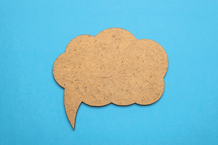 Speech bubble crepe paper balloon label on blue background. Copy space.の写真素材