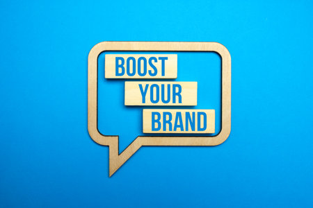Boost your brand on blue paper background. Wooden speech bubble with boost your brand text.の写真素材
