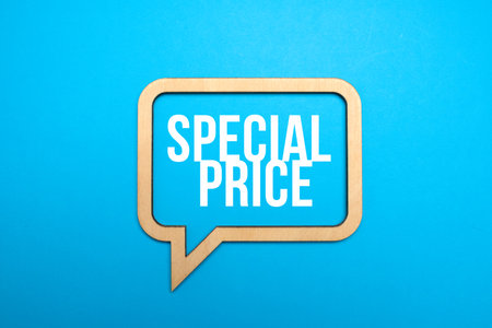 Sale symbol. Concept words Special price in wooden speech bubbles on blue paper background. Big sale concept. Copy space.の写真素材