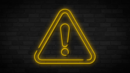 Yellow neon danger sign on brick wall. Elements of web set. Simple icon for websites, web design, mobile app, info graphics.の写真素材