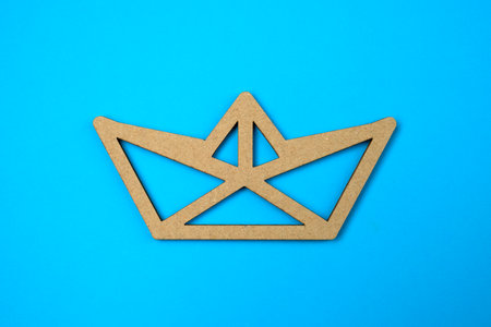 Paper cut boat on blue background. The concept of success and safety. Good conditions. Reliable business.の写真素材