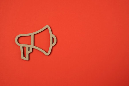 Paper cut cartoon megaphone on red background. Social media, marketing concept.の写真素材