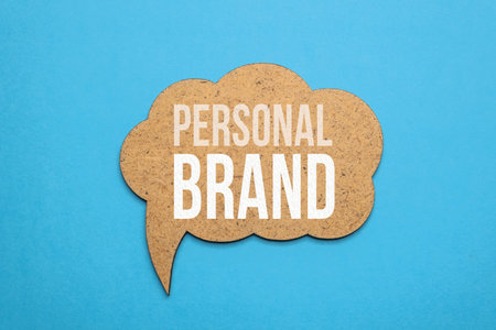 Personal brand sign on blue paper background. Personal branding wooden speech bubble. Personal brand tag. Personal branding banner.の写真素材