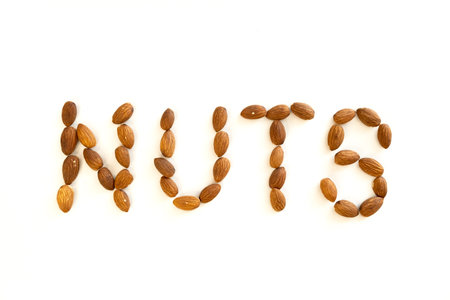 The word nuts made up of almond nuts. Vitamin organic protein food. Top view.