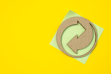 Recycling symbol from cardboard and paper packaging with copy space.