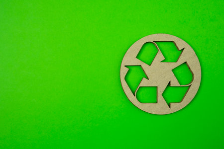Paper cut of recycle logo on green background with free copy space for your creativity ideas text.