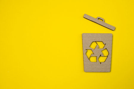 Paper garbage container symbol on yellow background. Trash cans, bins. Global campaign against...
