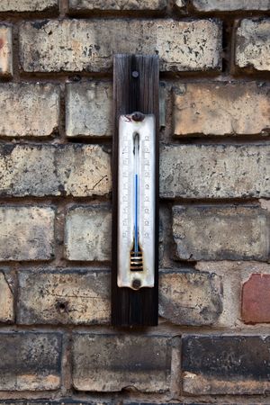 old centigrade thermometer on an shabby brick wallの写真素材