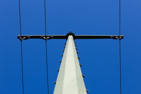 overhead line span pole in front of blue sky